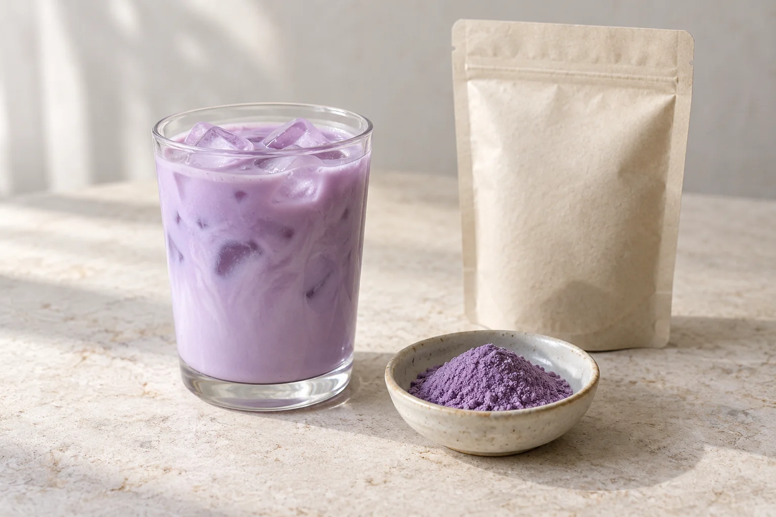 Illustration of a purple iced drink, a dish of purple powder and a plain unbranded pouch
